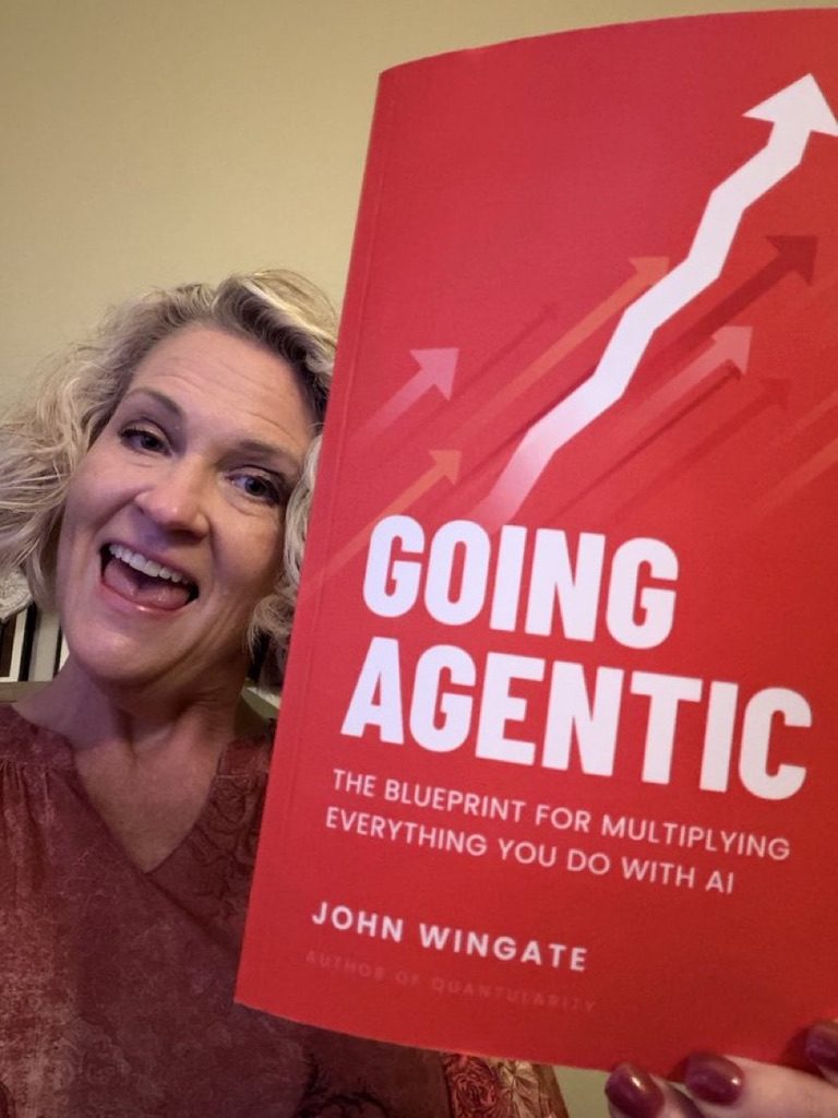 A reader smiling with a copy of Going Agentic