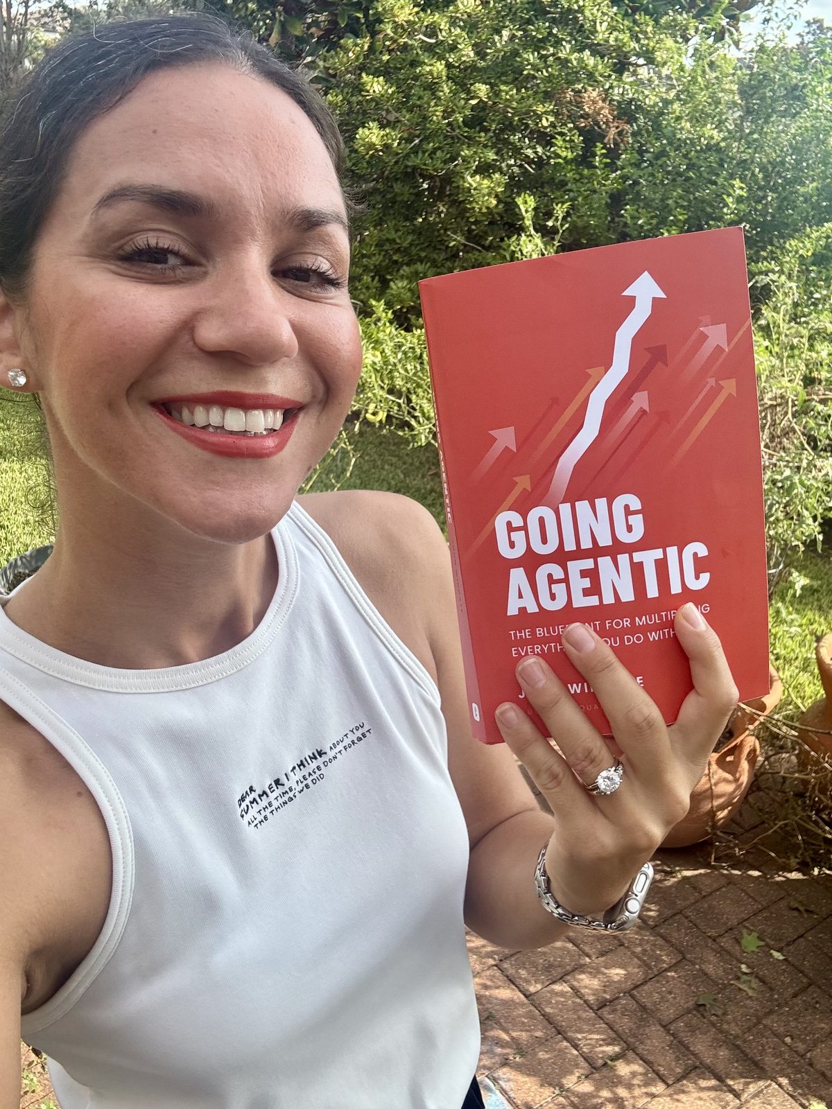 A reader smiling with her copy of Going Agentic