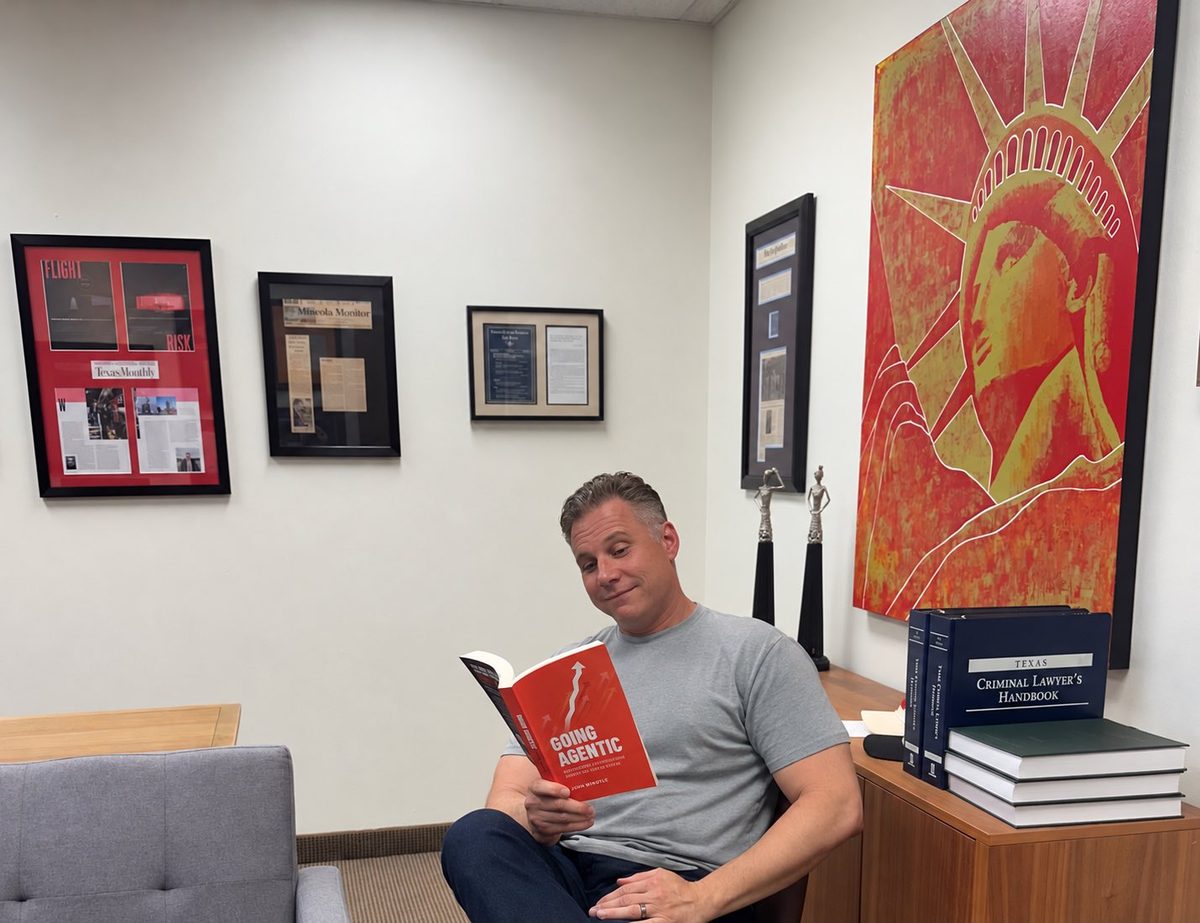 A reader reading Going Agentic in his office