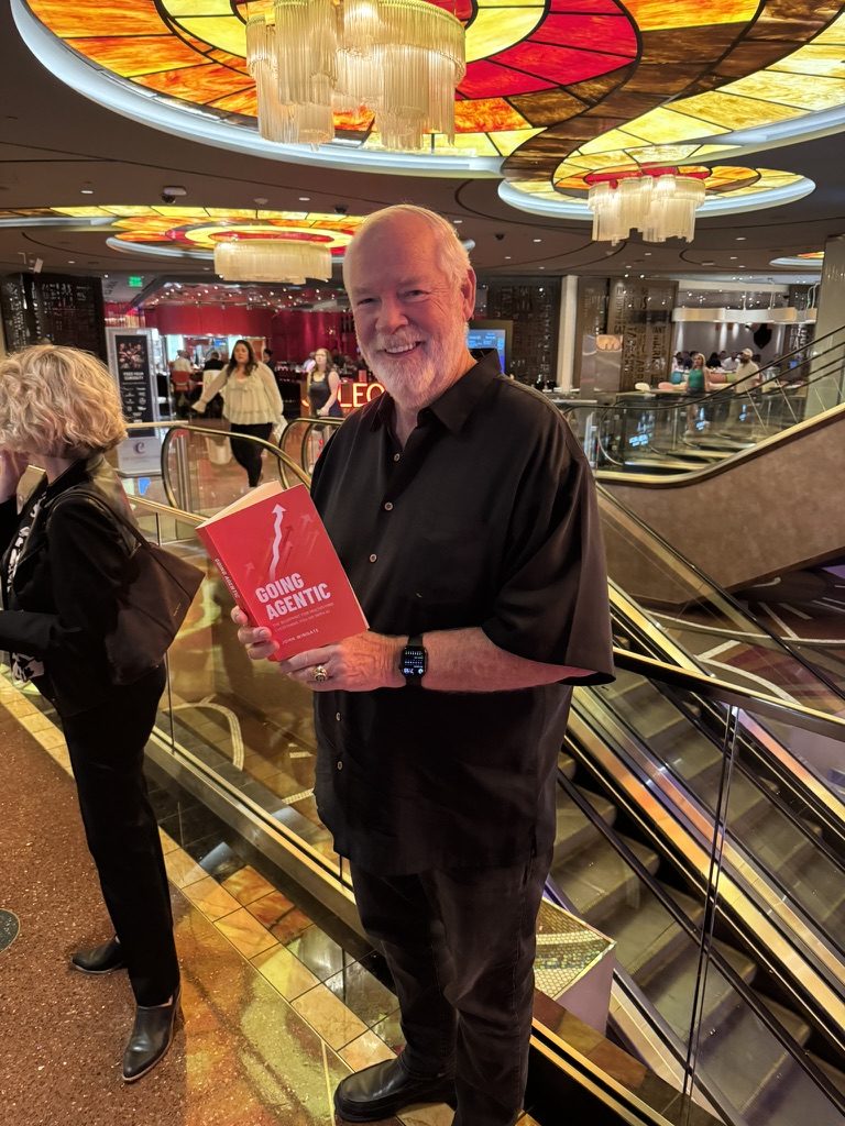 A reader holding Going Agentic at a resort