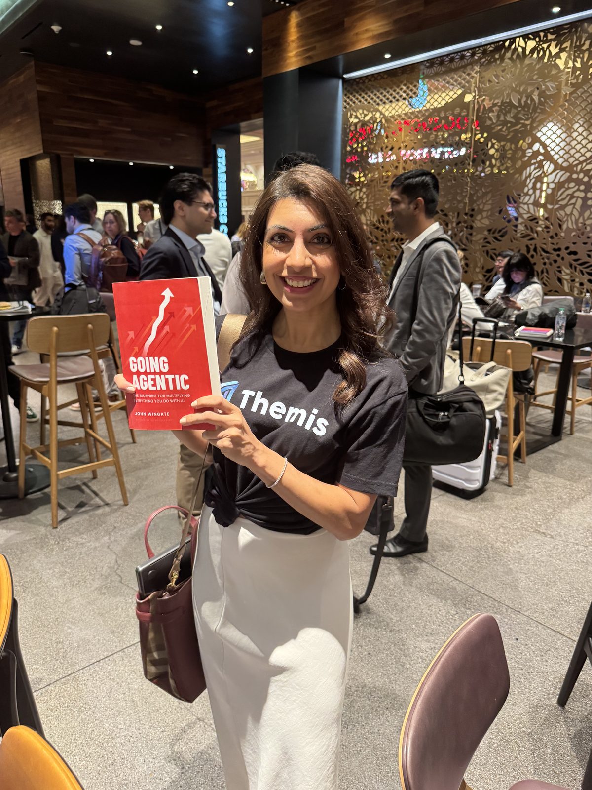 A reader holding Going Agentic at an event