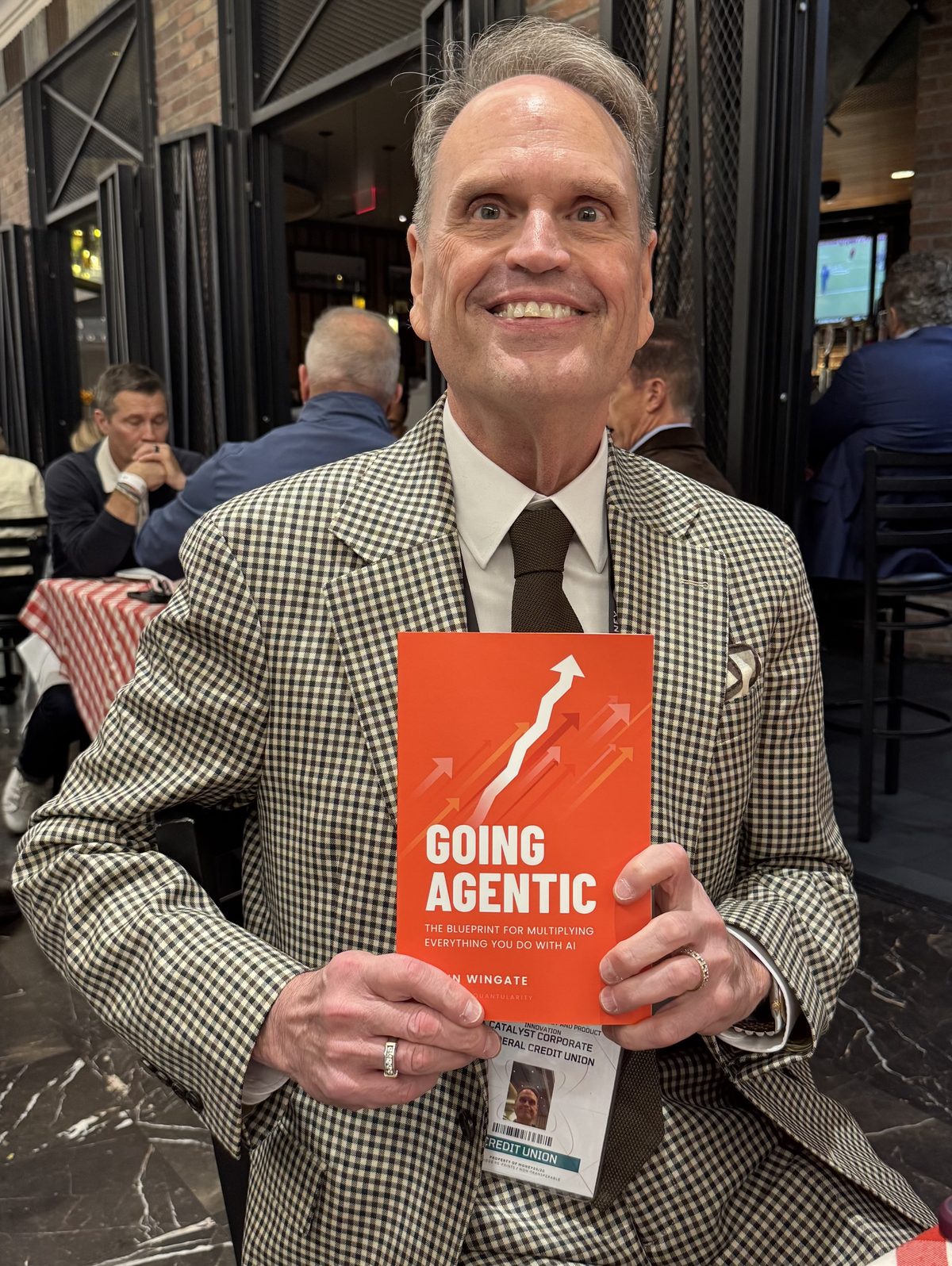 A reader with Going Agentic at an event